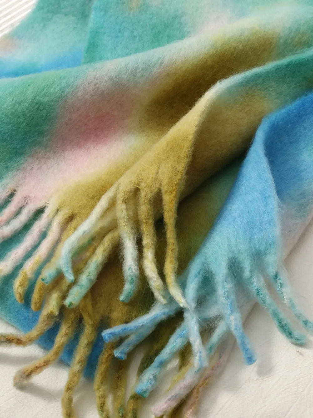 Tie-dye polyester scarf with fringe ends, soft blue-green with yellow and pink tones