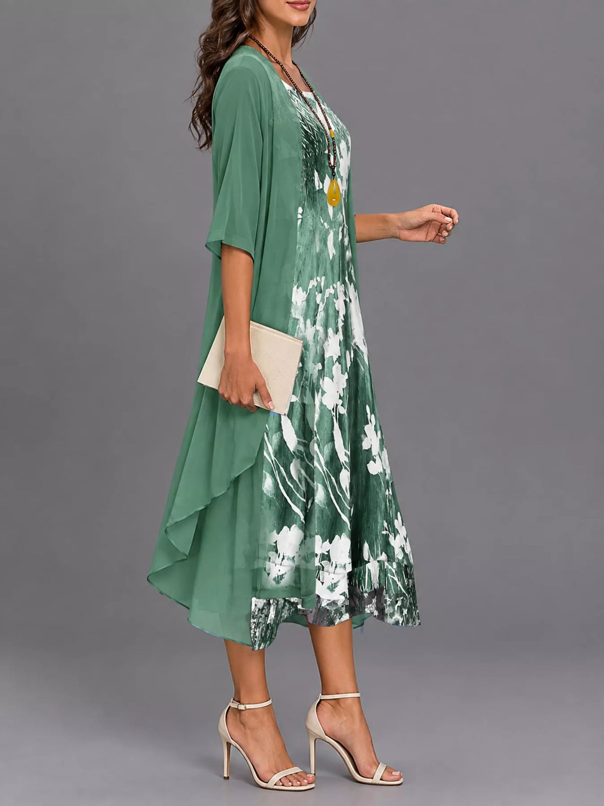 Green floral print midi dress with sheer chiffon cardigan, side view, draped mid-calf hem