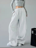 White oversized wide-leg drawstring pants with elastic waistband and side pockets