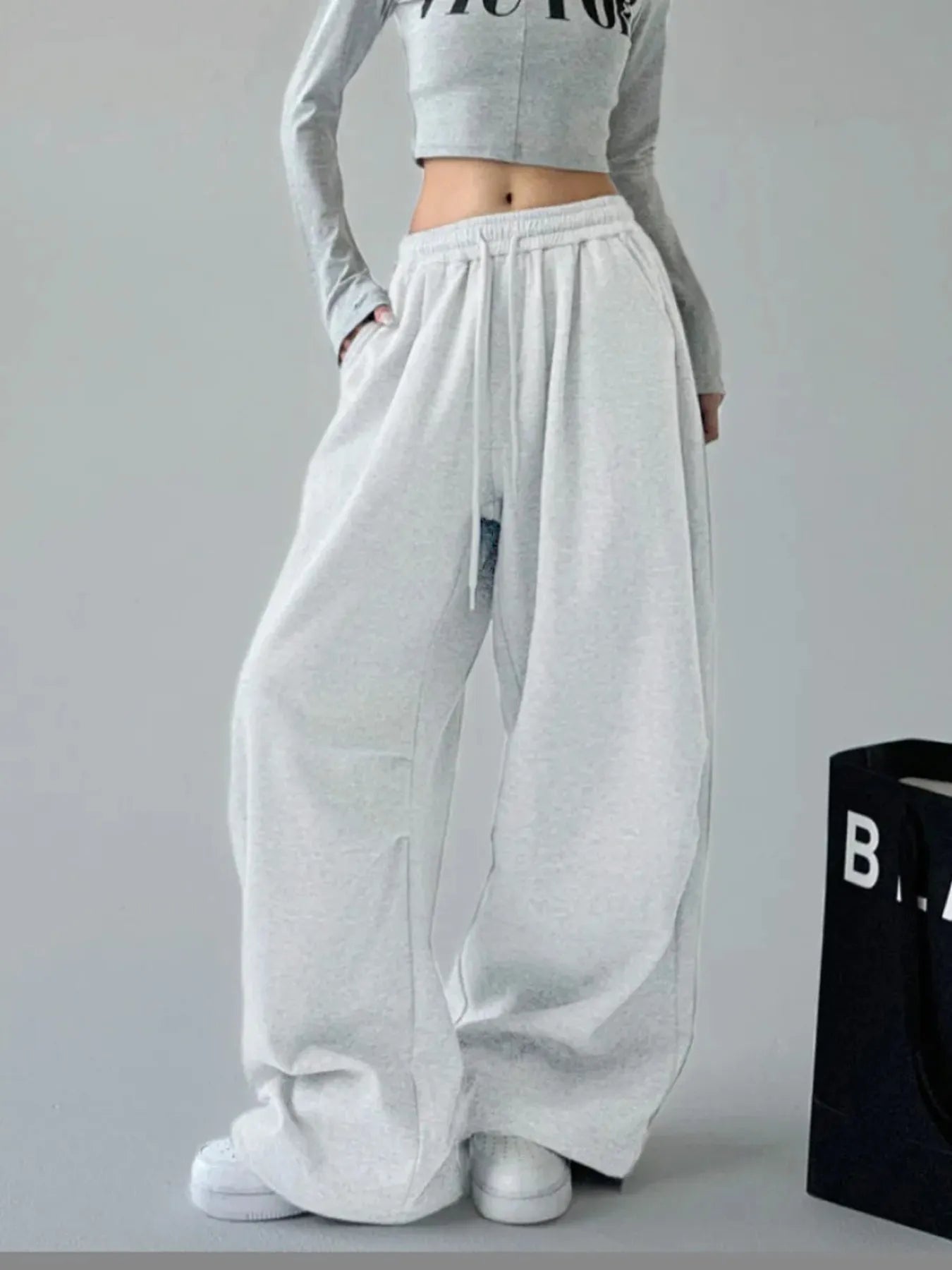 White oversized wide-leg drawstring pants with elastic waistband and side pockets