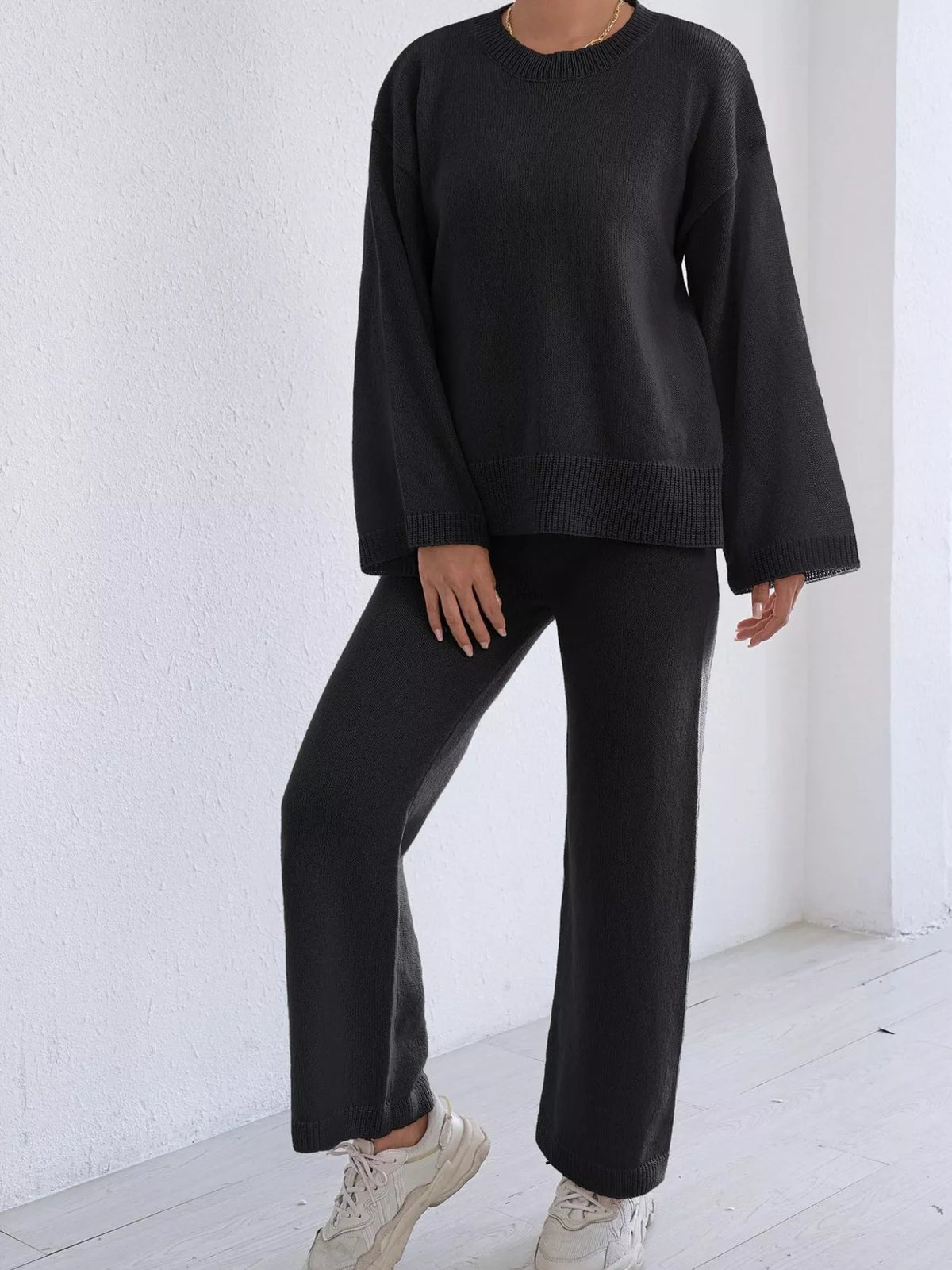 Black dropped-shoulder knit sweater and wide-leg pants set, ribbed hem and cuffs