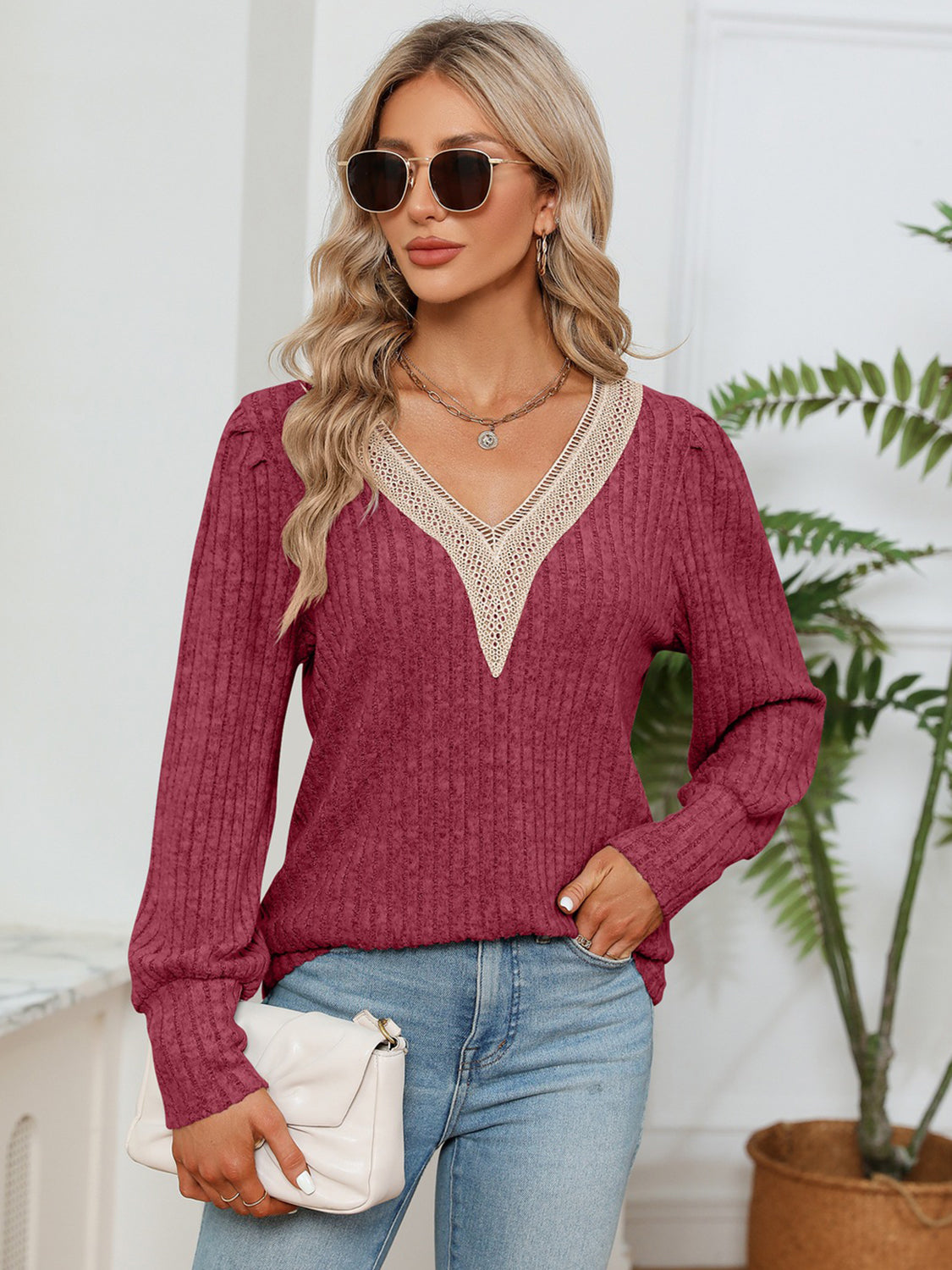 Brick red ribbed knit blouse with lace V-neck trim and long sleeves