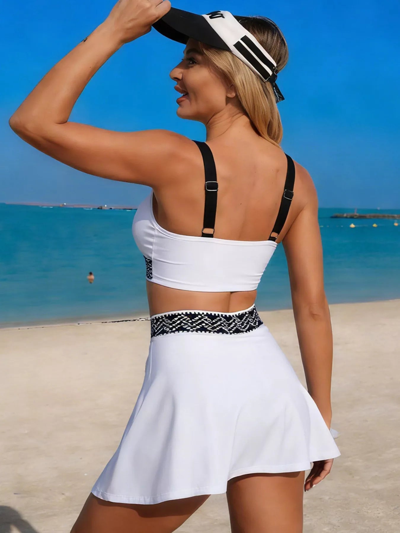 Trendsi Contrast Trim Tank and Skort Swim Set: white top with black straps and patterned waistband on beach model