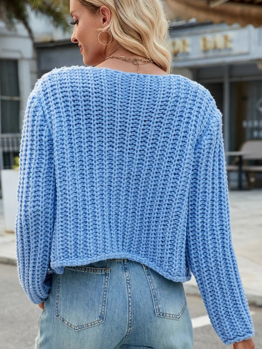 Sky blue knit cardigan back view with long sleeves and round neckline with buttons