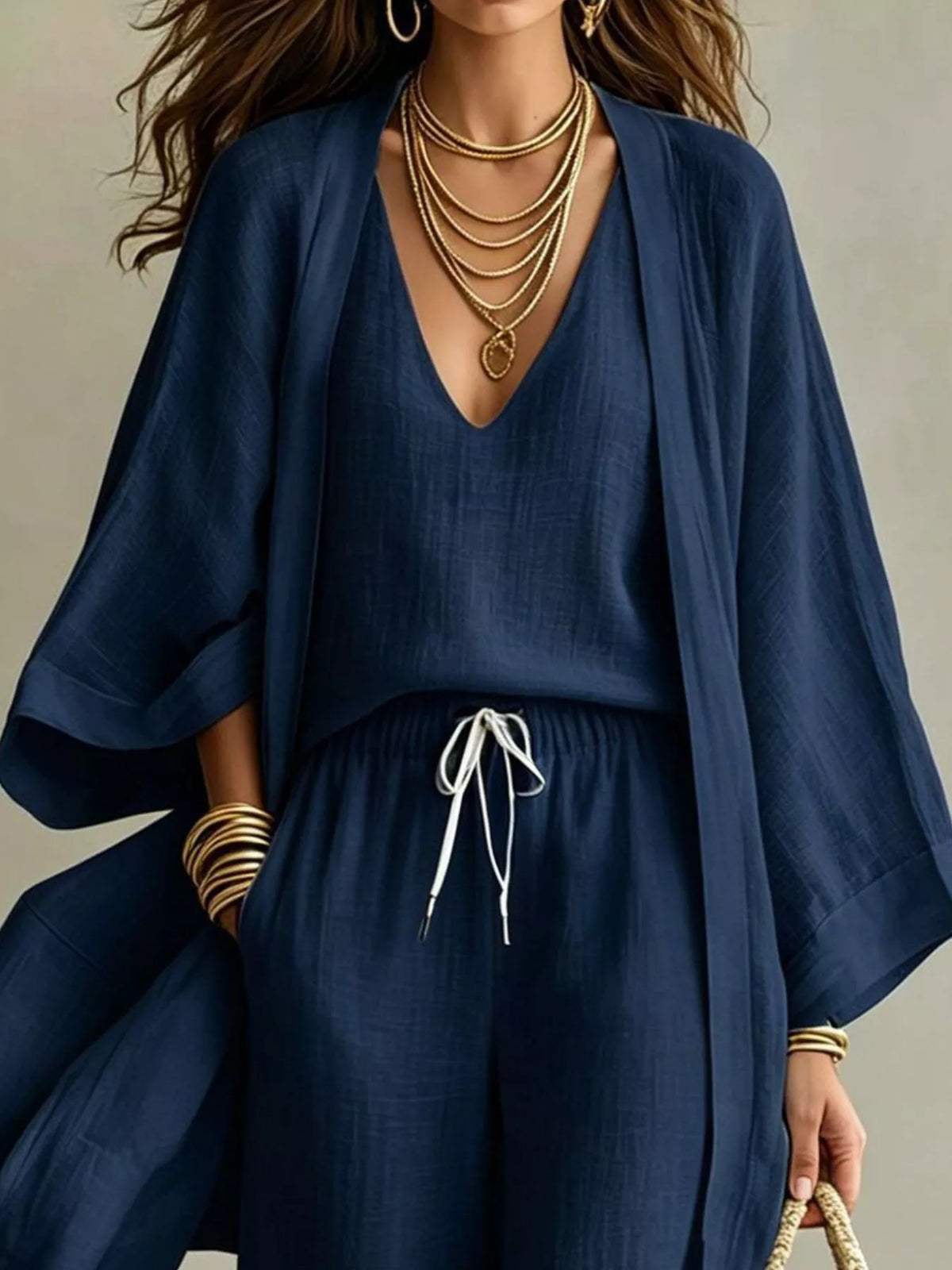 Navy three-piece outfit set with V-neck top, drawstring wide-leg pants, and open cardigan
