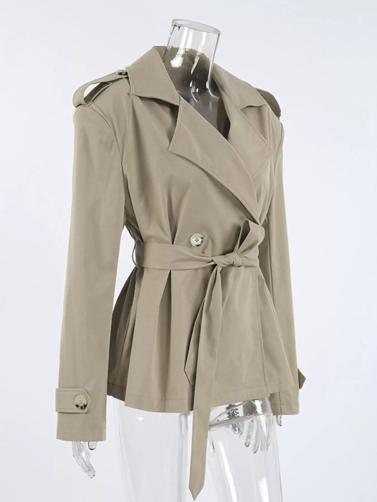 Khaki belted trench coat on mannequin with diagonal front wrap and gold button front