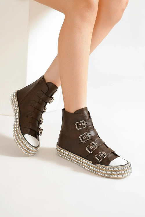 Dark brown platform sneakers with multi-buckle straps and studded sidewall