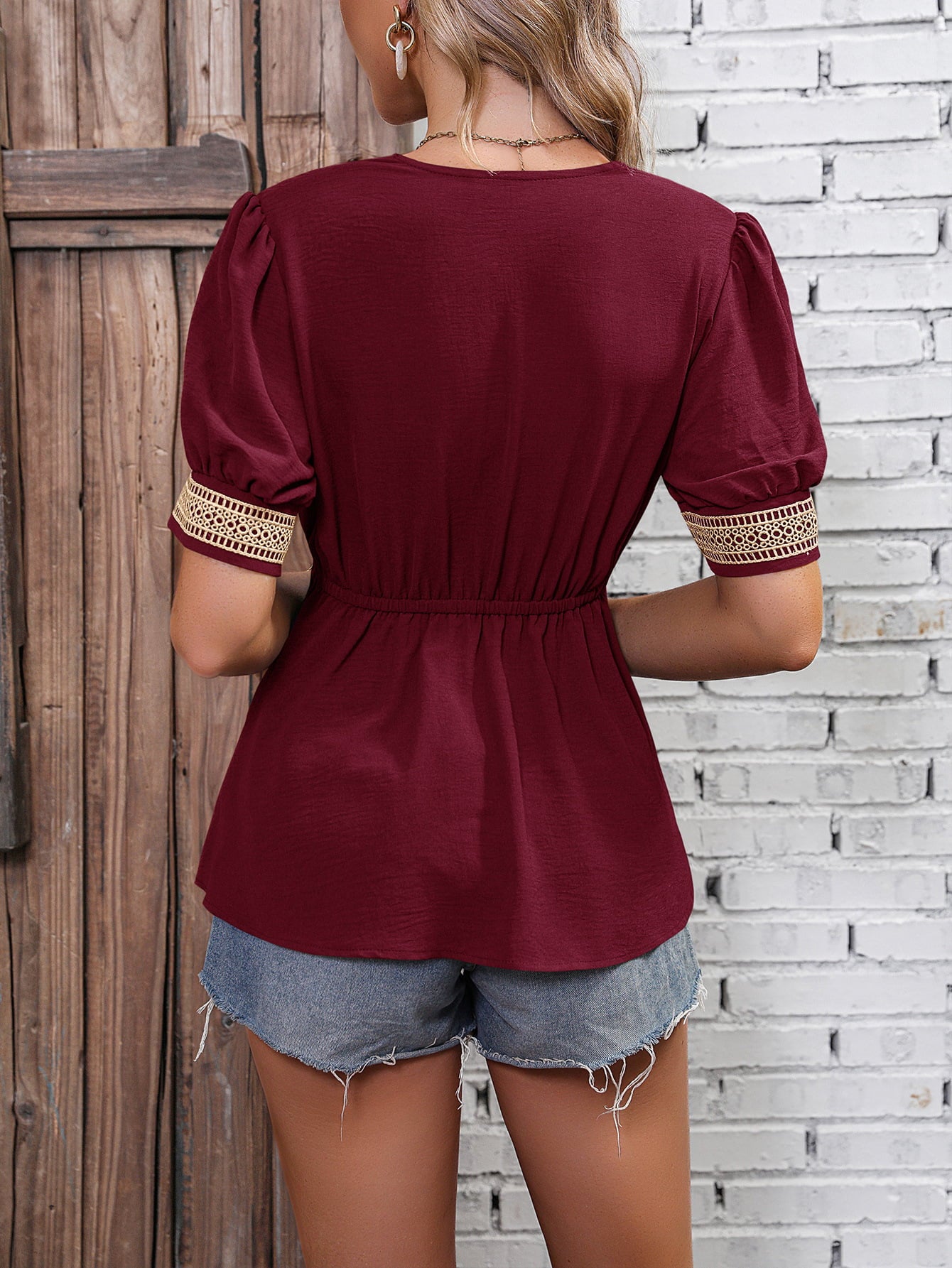 Wine babydoll top back view with puff sleeves and gathered waist, lace-trim cuffs