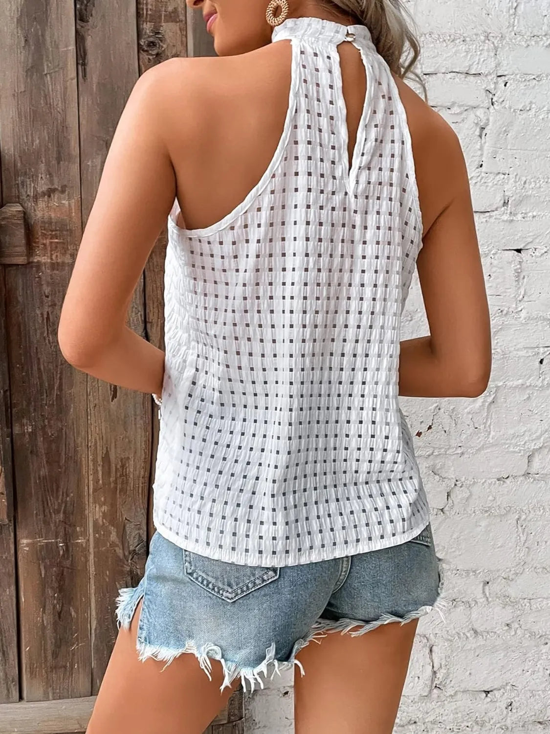 White textured sleeveless cami with open back and gathered high neck
