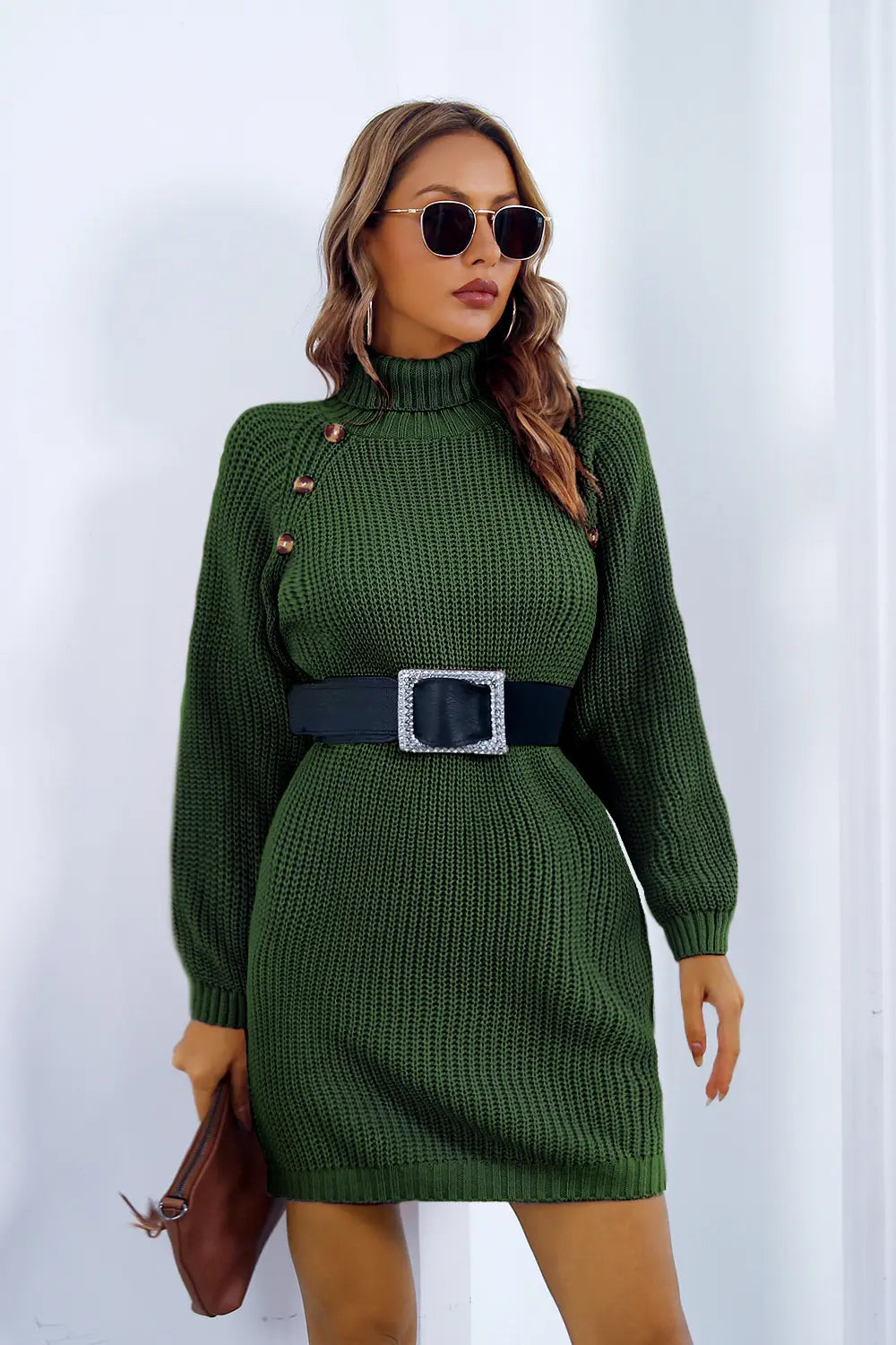 Green knit turtleneck sweater dress with long sleeves, button placket and black belt