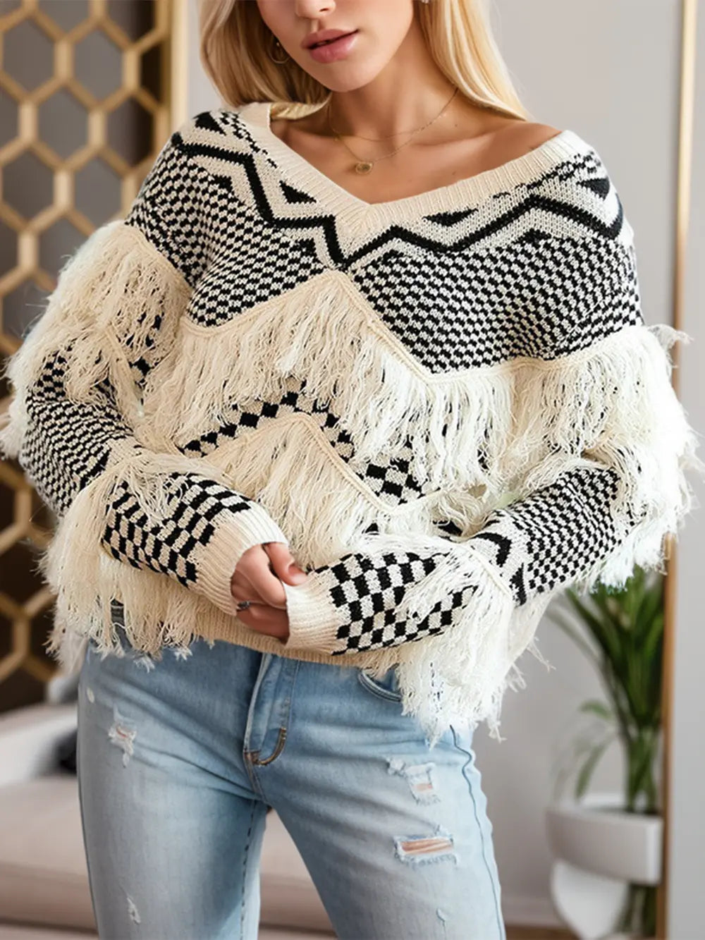 Beige and black geometric knit V-neck sweater with oversized fringe pattern at chest