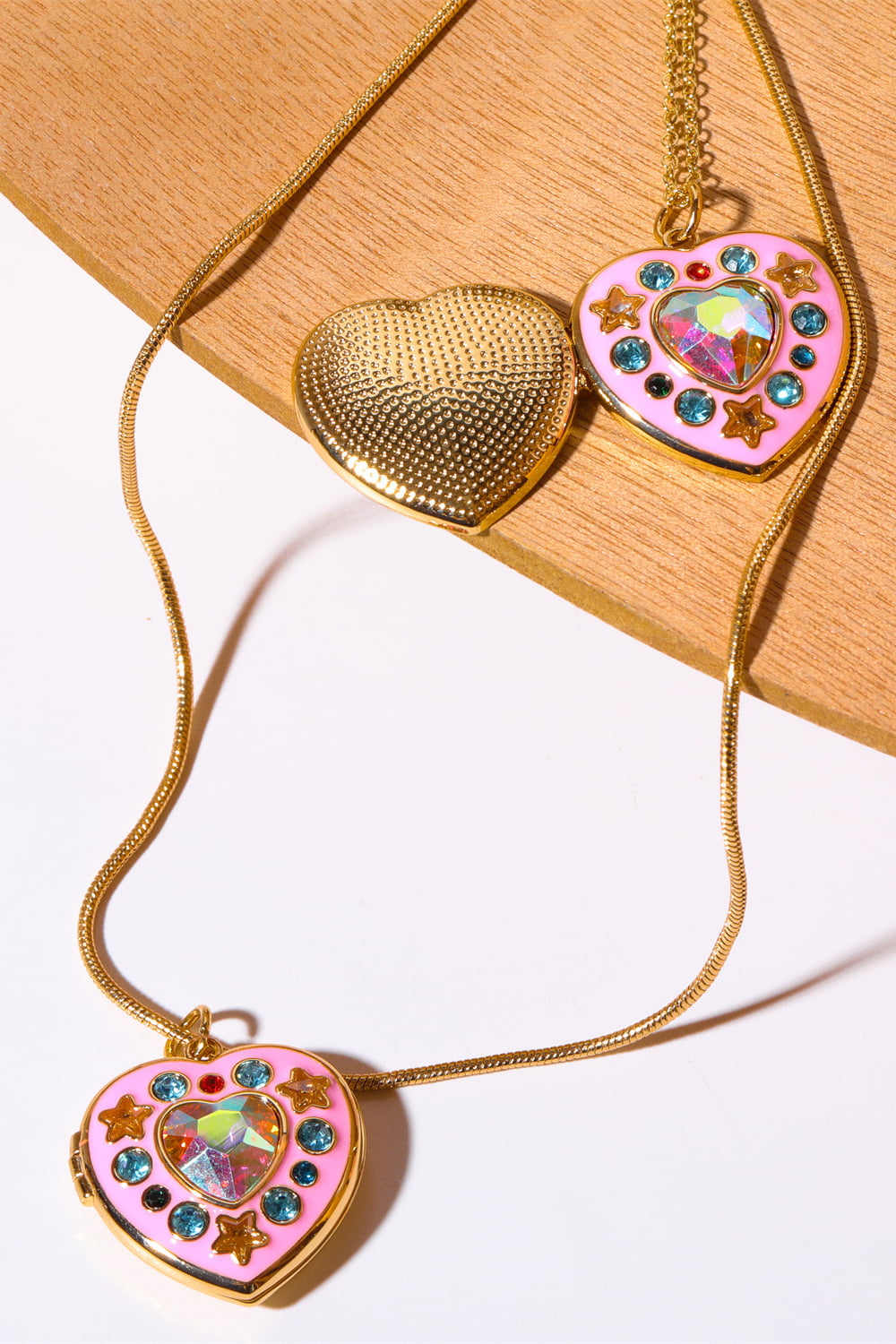 Gold-tone heart box pendant necklace with pink heart charm and rhinestone heart gem