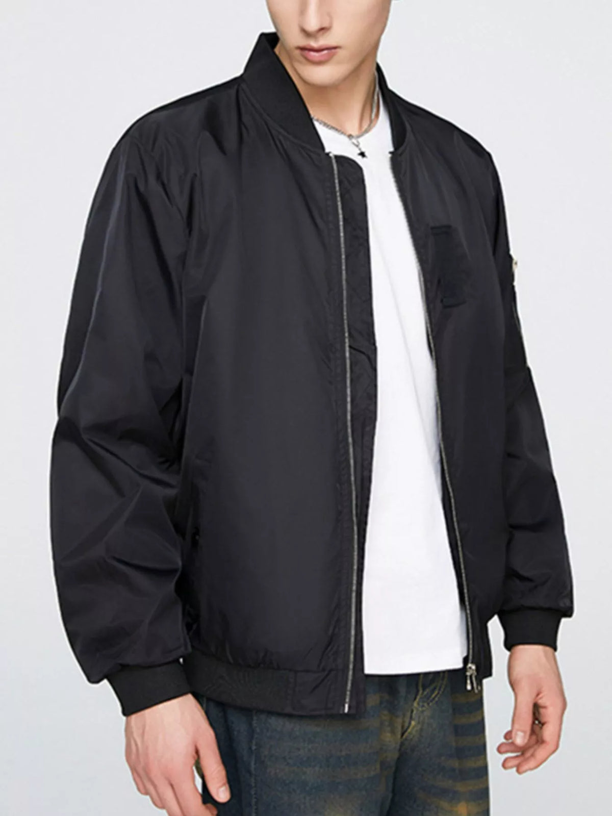 Black men’s bomber jacket with front zip, ribbed collar and cuffs, and small chest pocket