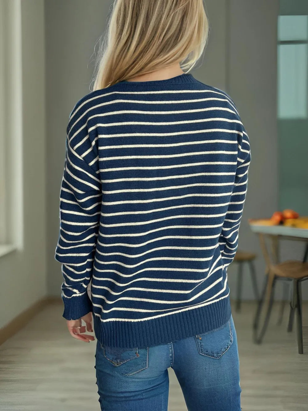 Back view of striped mock neck long-sleeve sweater in navy with cream horizontal stripes