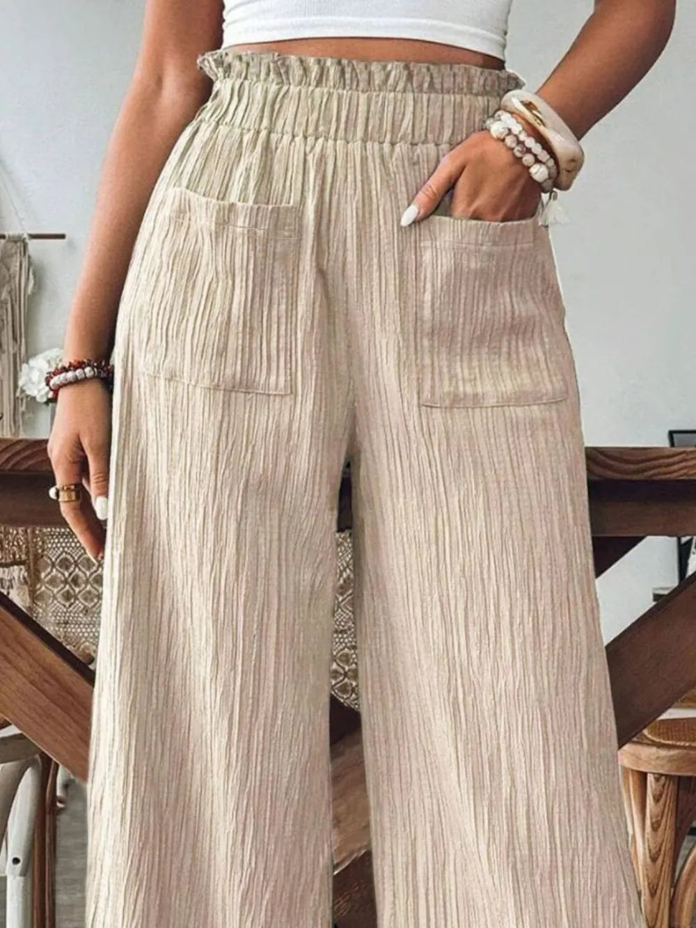Tan pocketed wide-leg pants with elastic waist, vertical texture and wide legs