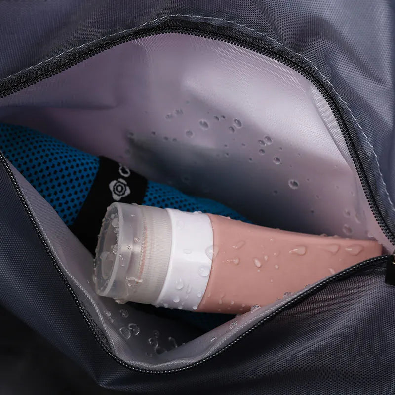 Dark interior pocket of a duffle bag with water-resistant bottle filling and zip closure