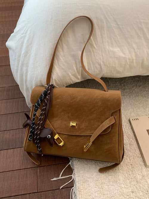 Brown suede shoulder bag with flap, gold buckle clasp, braided chain handle