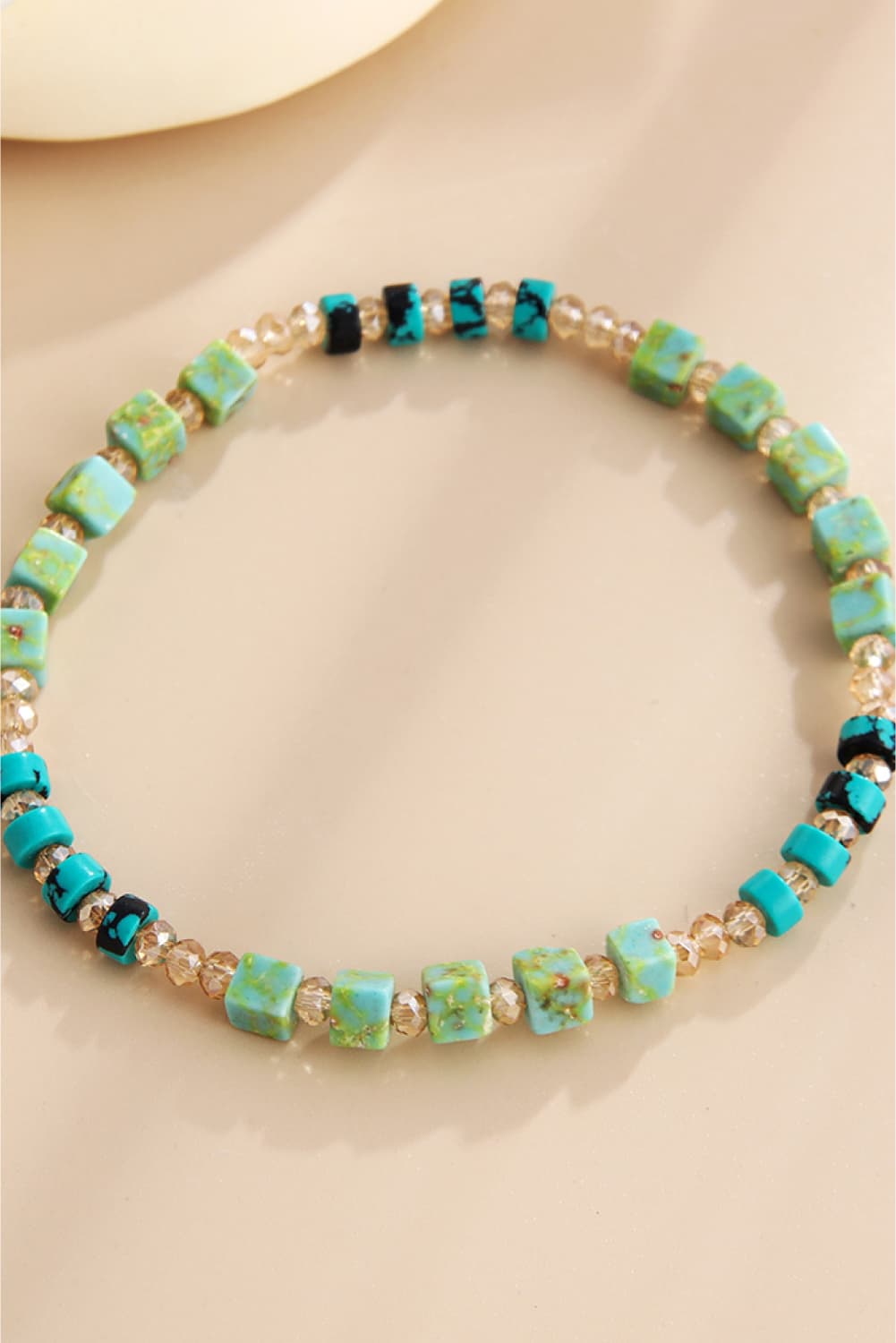 Beaded crystal and natural stone bracelet in teal and light green with gold spacers