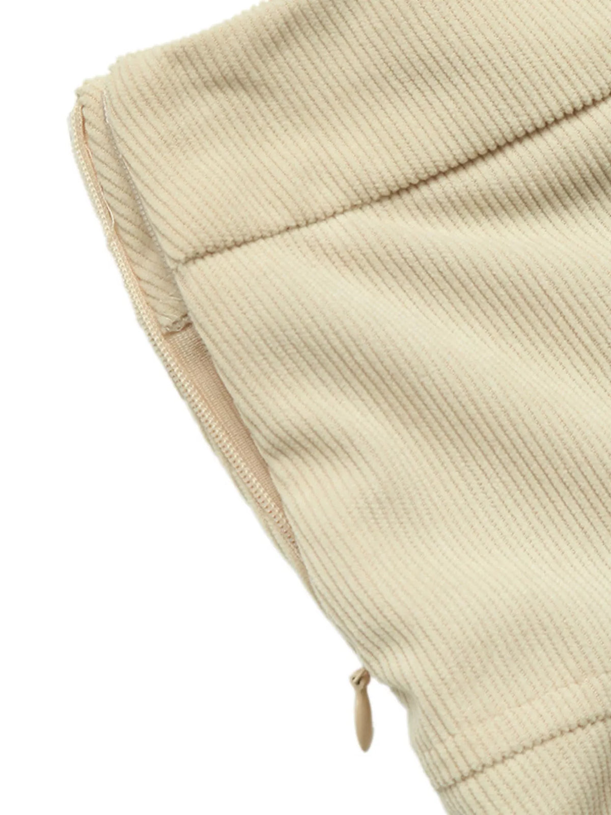 Close-up of khaki skirt fabric texture with folded hem detail