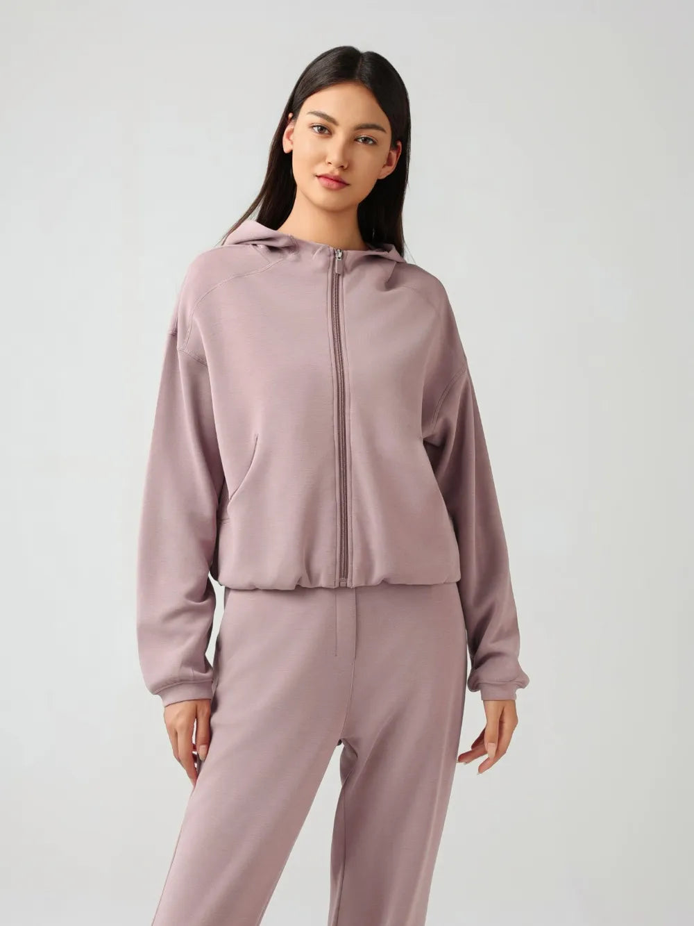 Dusty pink zip-up active hoodie with hood, full zipper, and elastic cuffs and hem