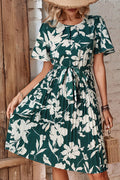 Forest green floral pleated dress with round neck and tied waist belt