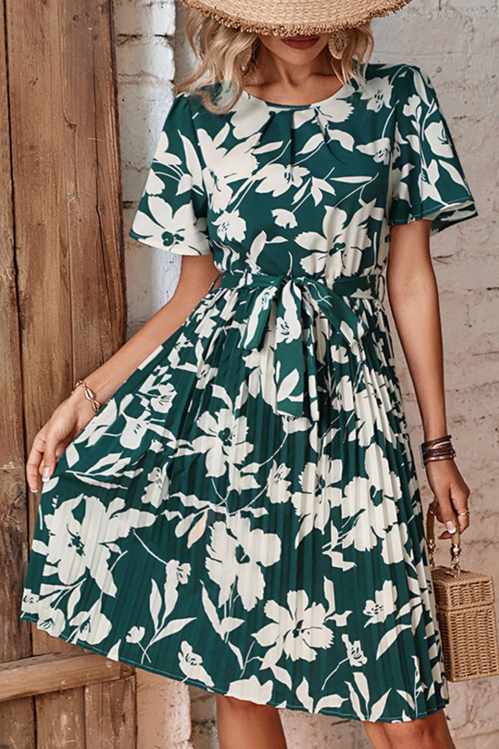 Forest green floral pleated dress with round neck and tied waist belt