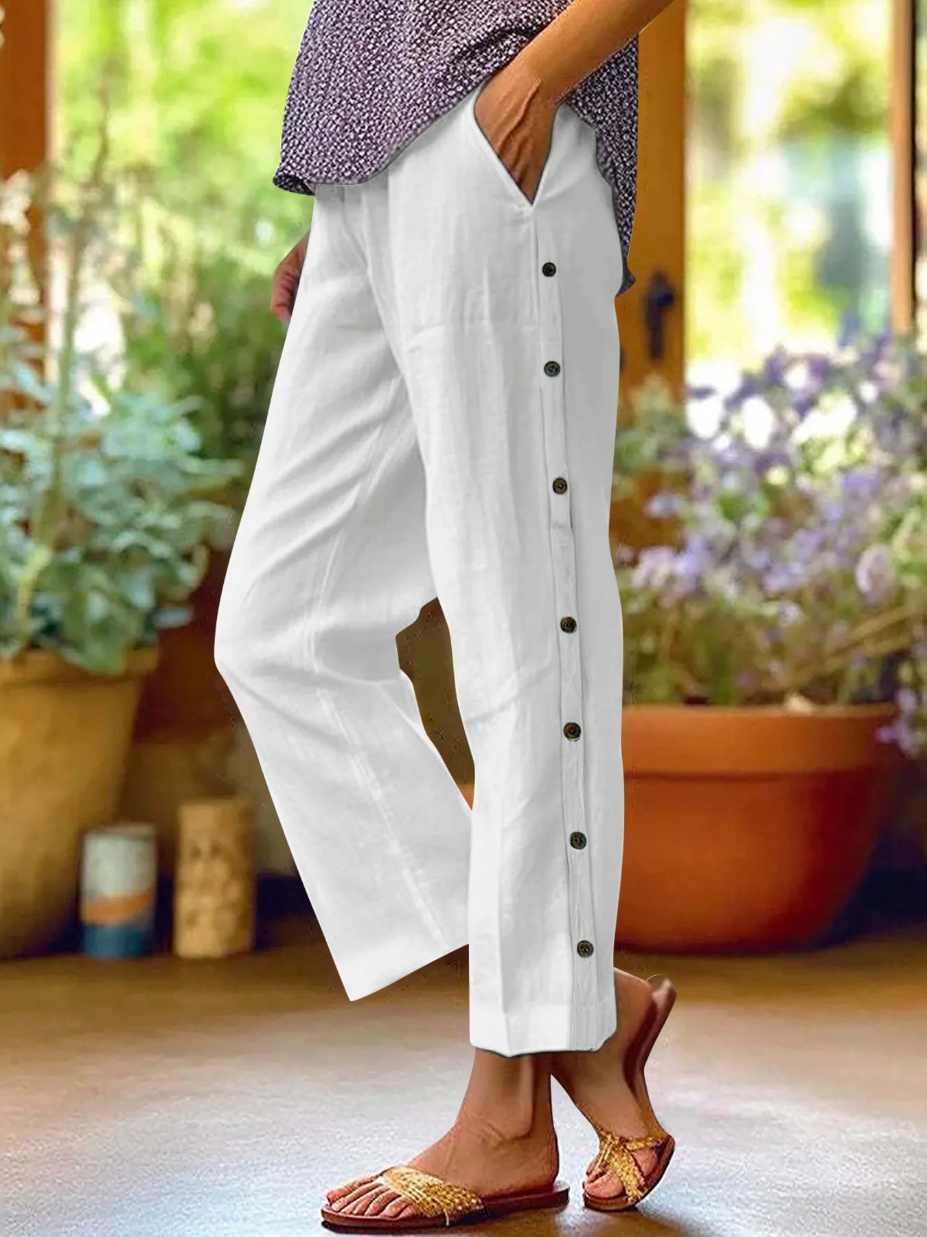 White wide-leg pants with side button trim and elastic waist