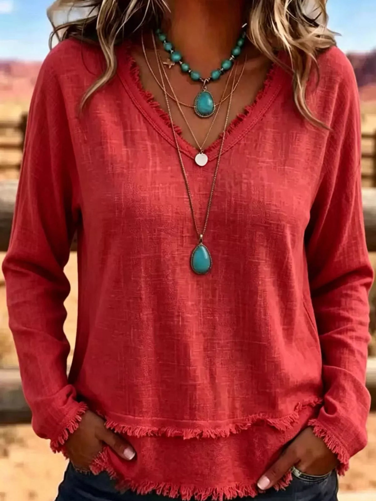 Red linen V-neck blouse with frayed hem, long sleeves, relaxed fit