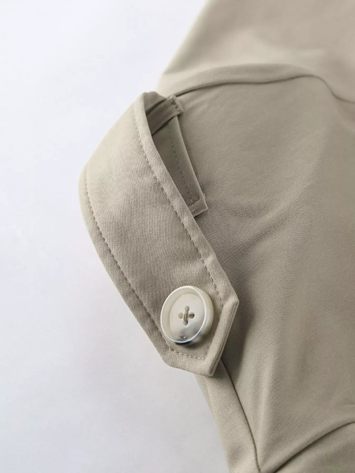 Khaki trench coat sleeve cuff with round button detail