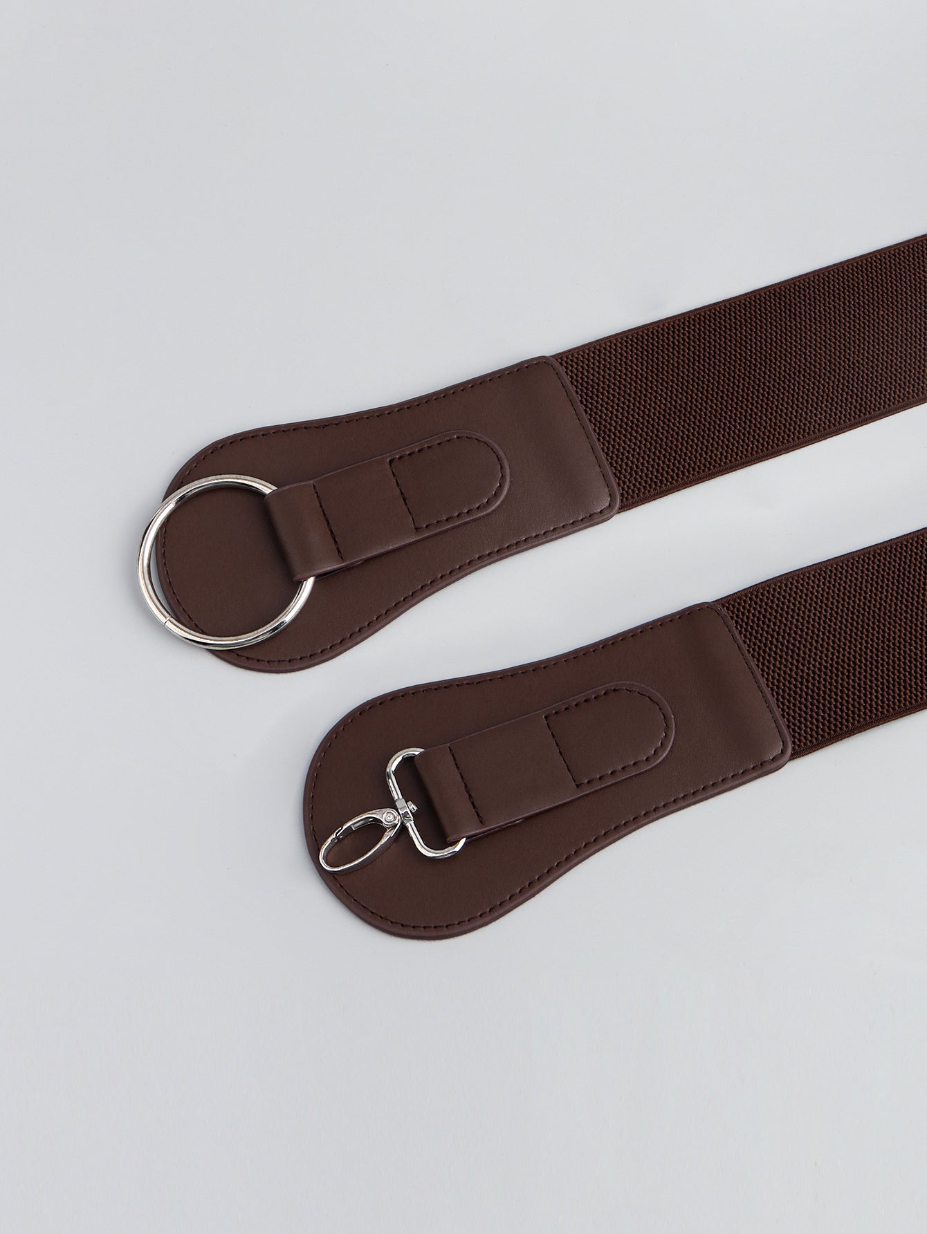 Caramel brown elastic vegan leather belt with oval buckle rings and stitched end tabs