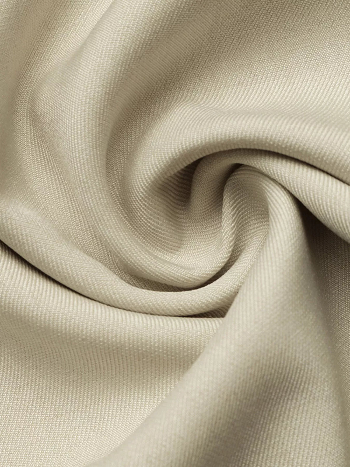 Khaki shirt dress fabric close-up with smooth woven texture and soft drape