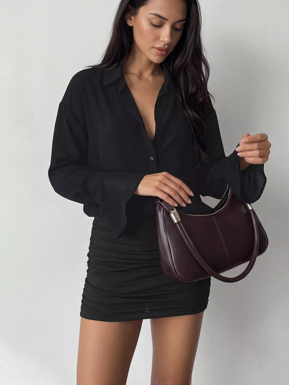 Black button-up mini dress with ruched bodycon skirt and flared sleeves