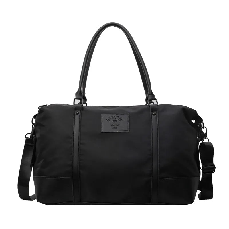 Black polyester travel duffel bag with detachable crossbody strap and top handles