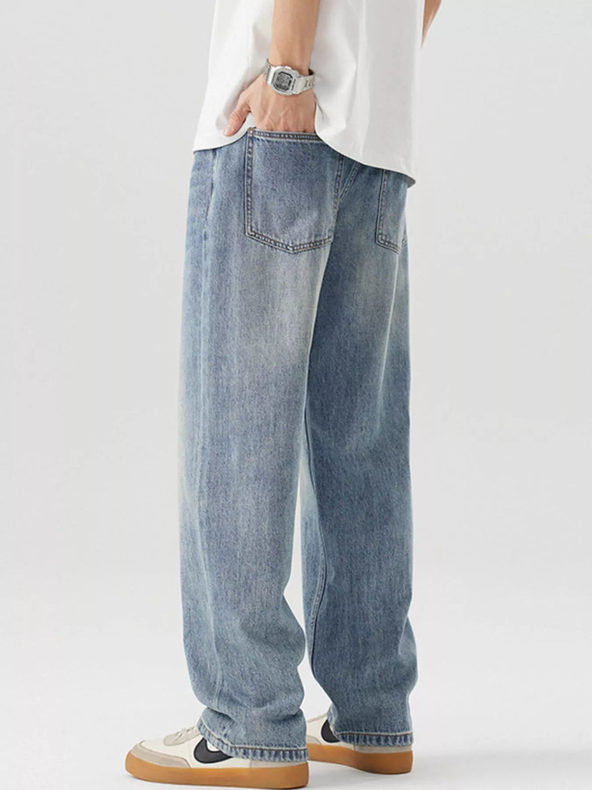 Blue vintage-wash loose-fit cotton jeans, back view with belt loops and pockets
