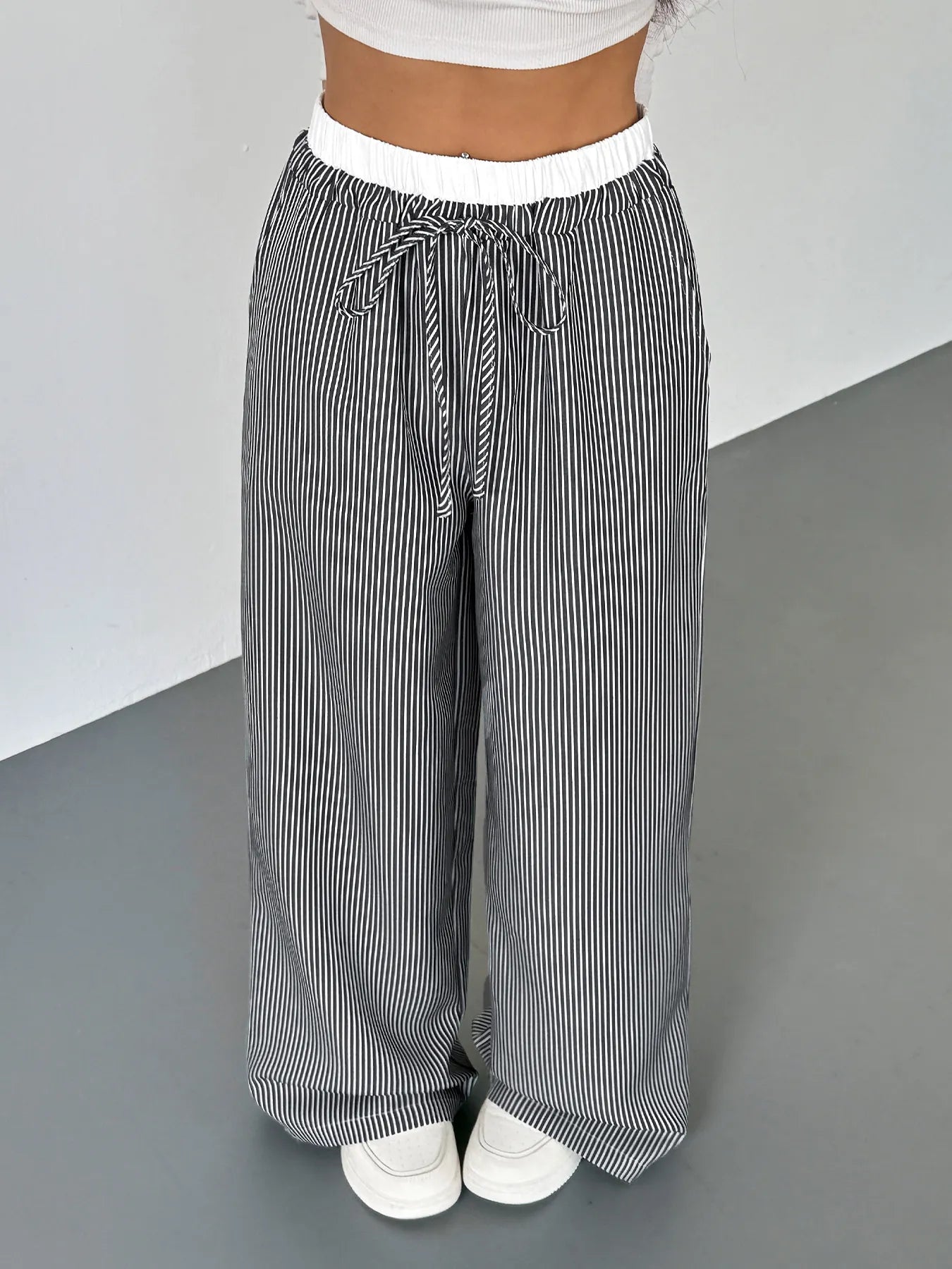Striped drawstring pants with elastic waistband, black-and-white vertical stripes