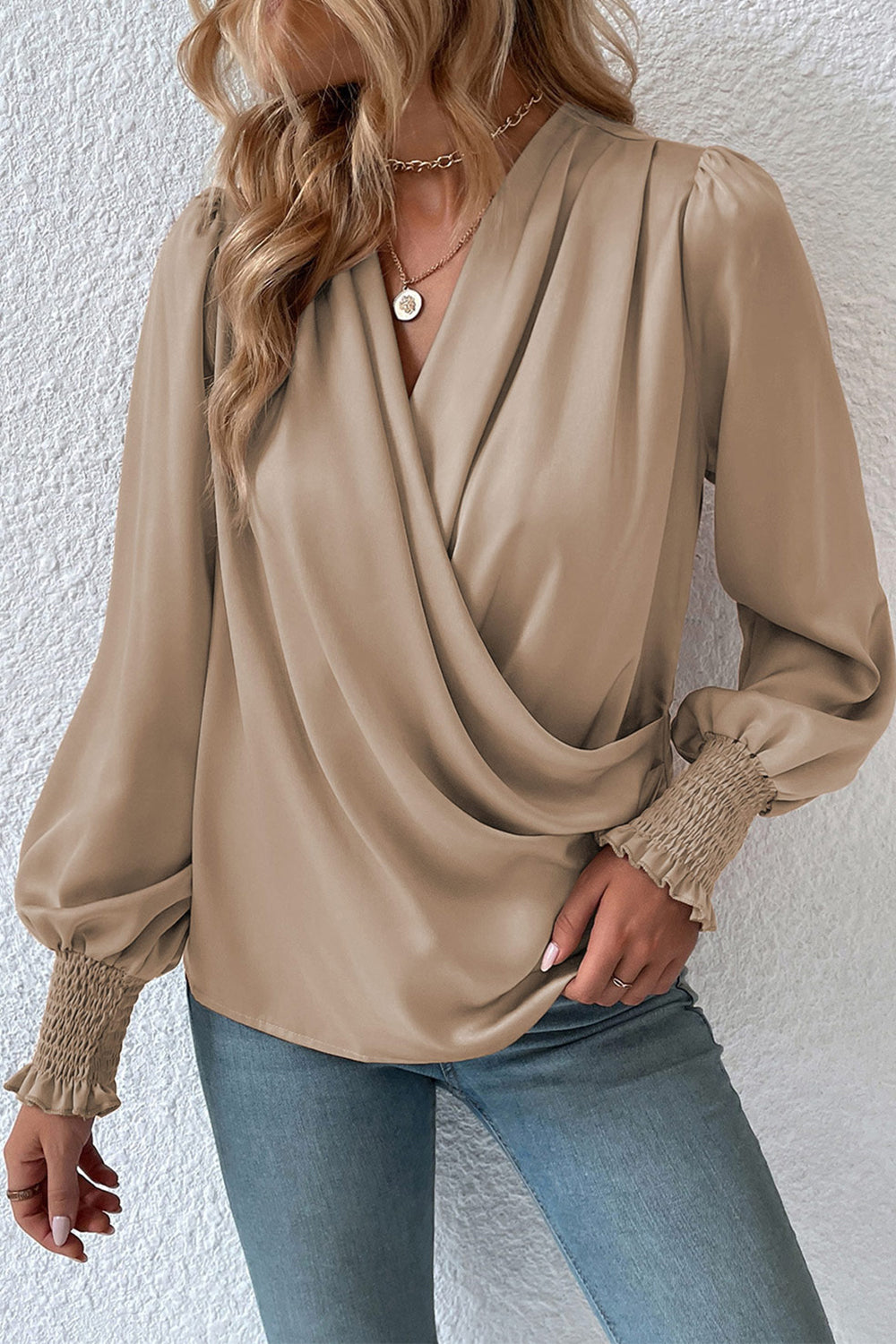 Khaki surplice-neck blouse with lantern sleeves and gathered cuff detail.