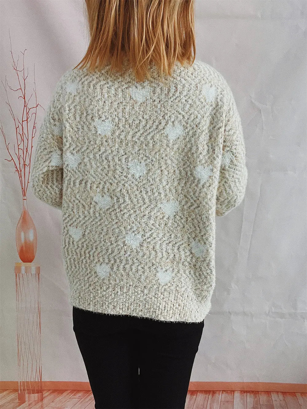 Heart-patterned heathered cream turtleneck drop-shoulder sweater, back view