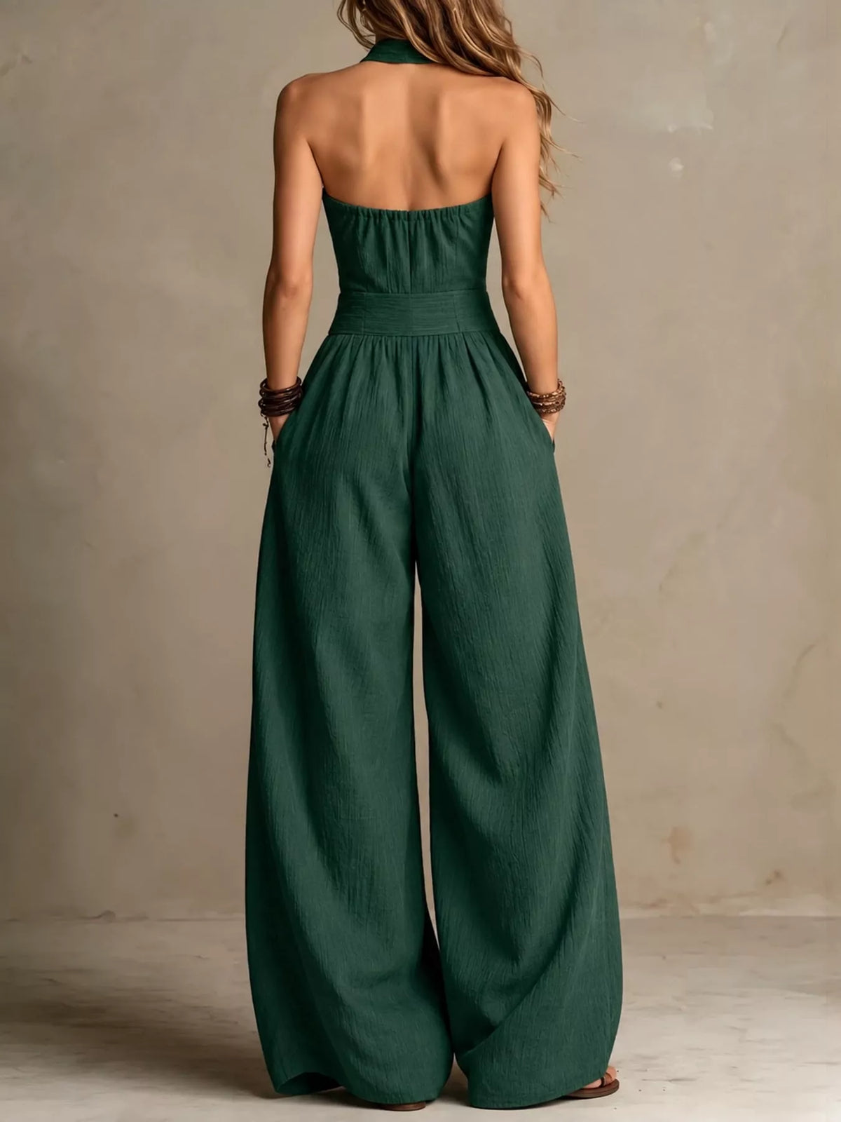 Dark green linen halter jumpsuit with smocked back and wide-leg pants