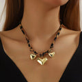 Gold-plated heart necklace with leopard-print chain and three heart charms