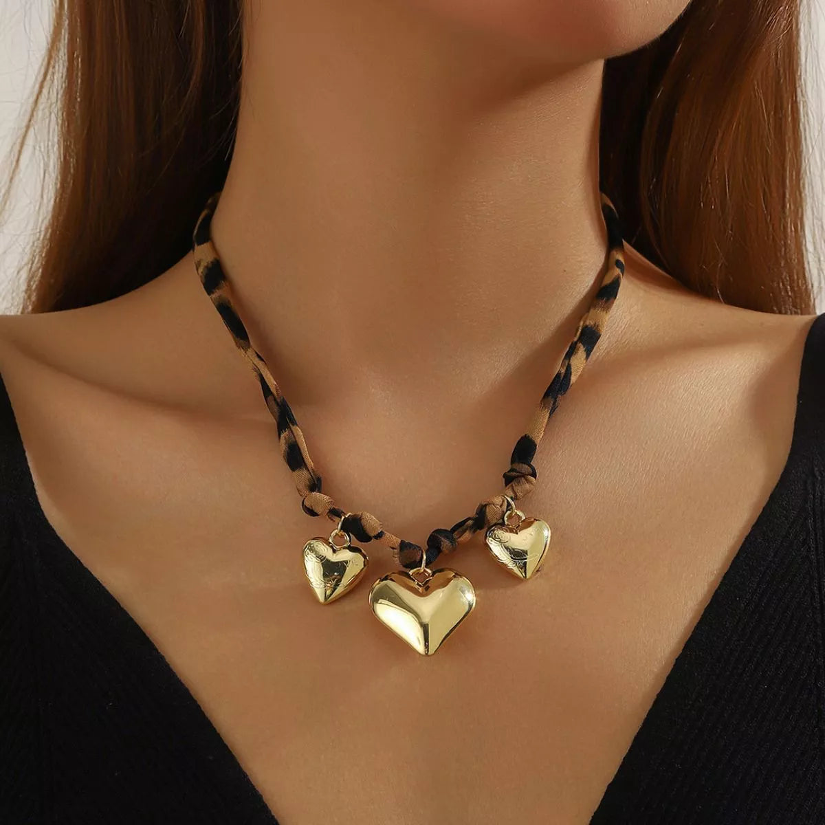 Gold-plated heart necklace with leopard-print chain and three heart charms