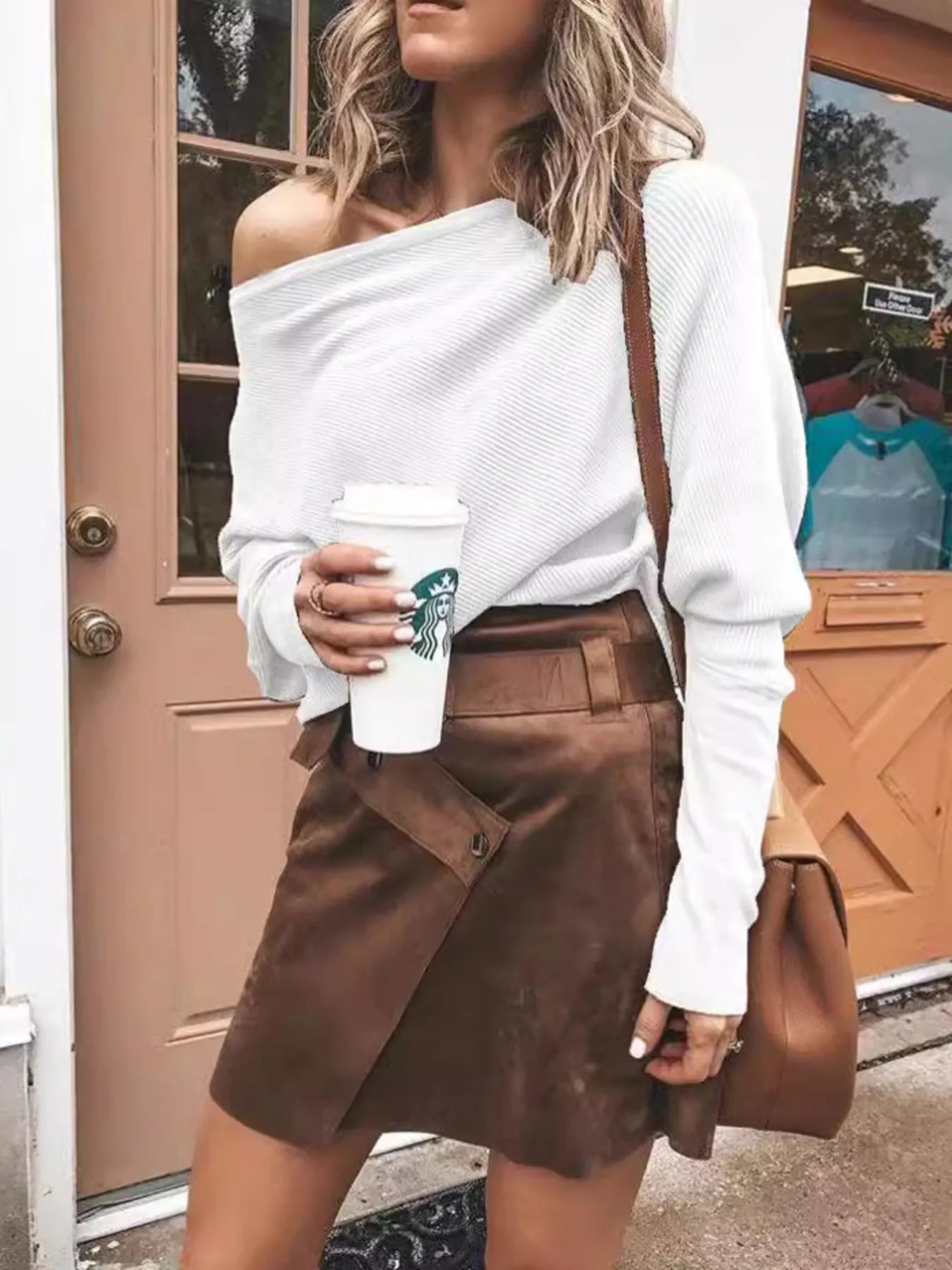 White one-shoulder ribbed sweater with draped shoulder and long sleeves.