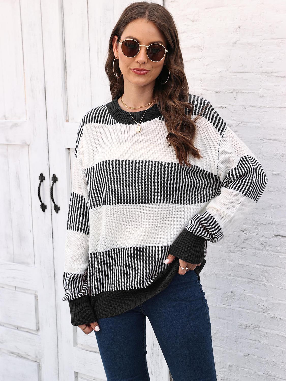 Striped knit sweater back view with round neck, drop-shoulder long sleeves in black and white