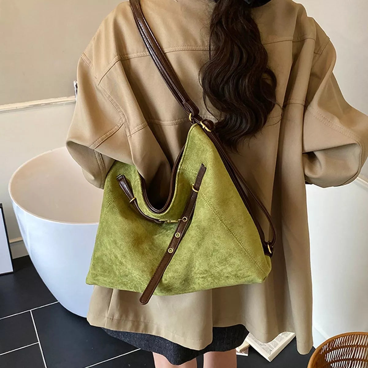 Medium green suede shoulder bag with brown contrast trim and buckled strap details
