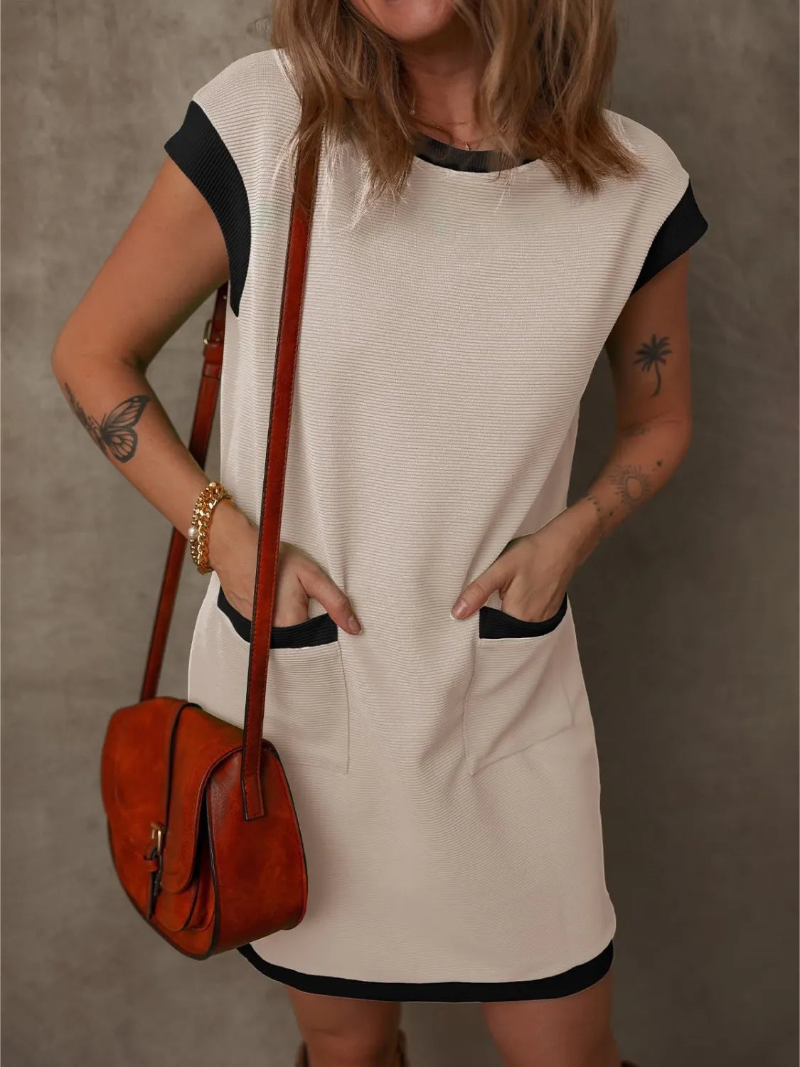 Round Neck Cap Sleeve Mini Dress in beige with black trim, pocketed design for casual yet polished look