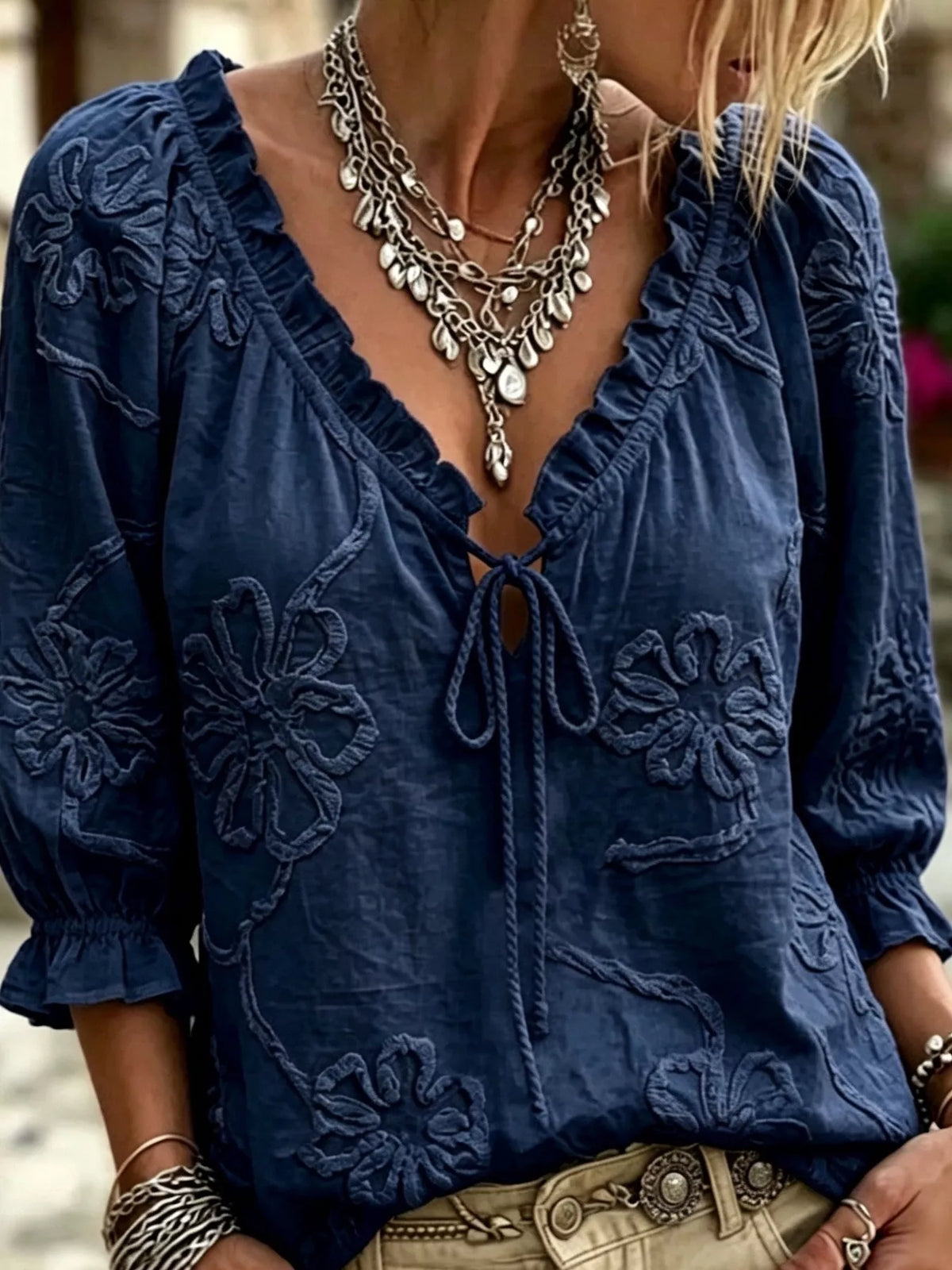 Navy floral embroidered tie-neck ruffled blouse with bow-tie front and long sleeves
