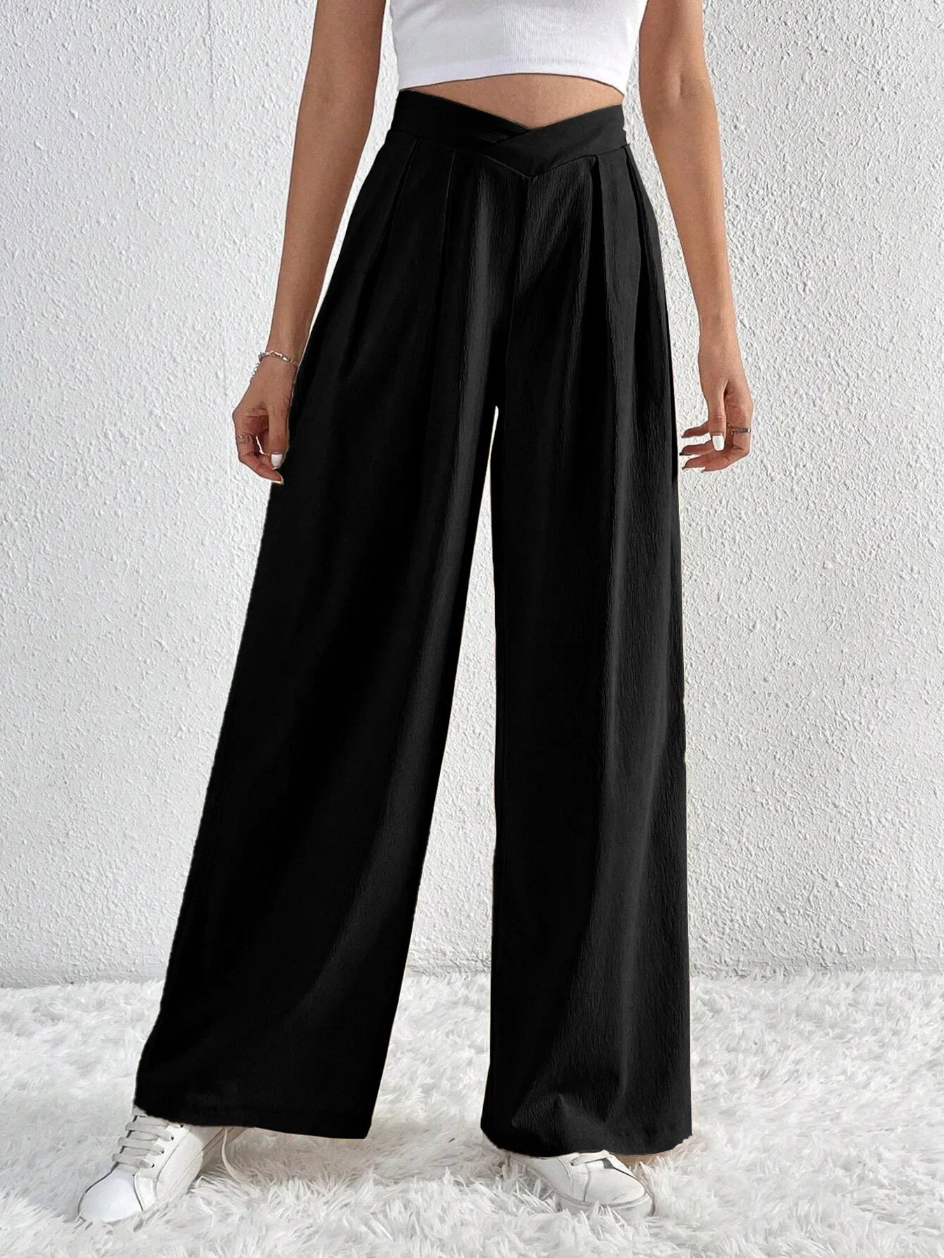 Black wide-leg pants with ruched V-waist and flowy wide-leg silhouette