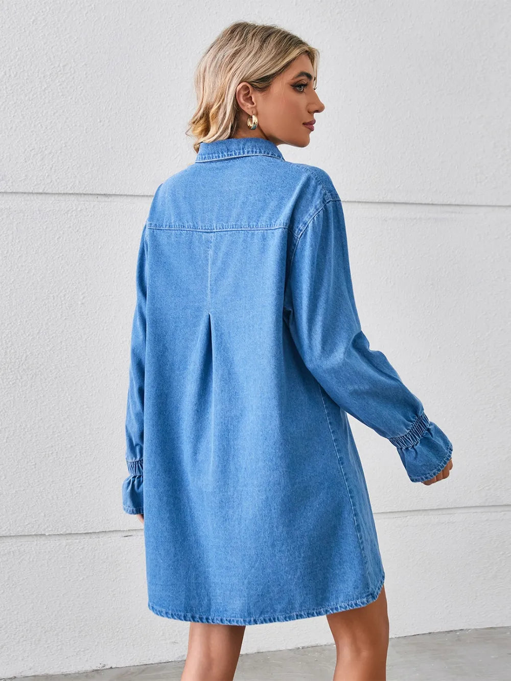Dusty blue denim mini dress, back view, dropped shoulders, button front, long sleeves