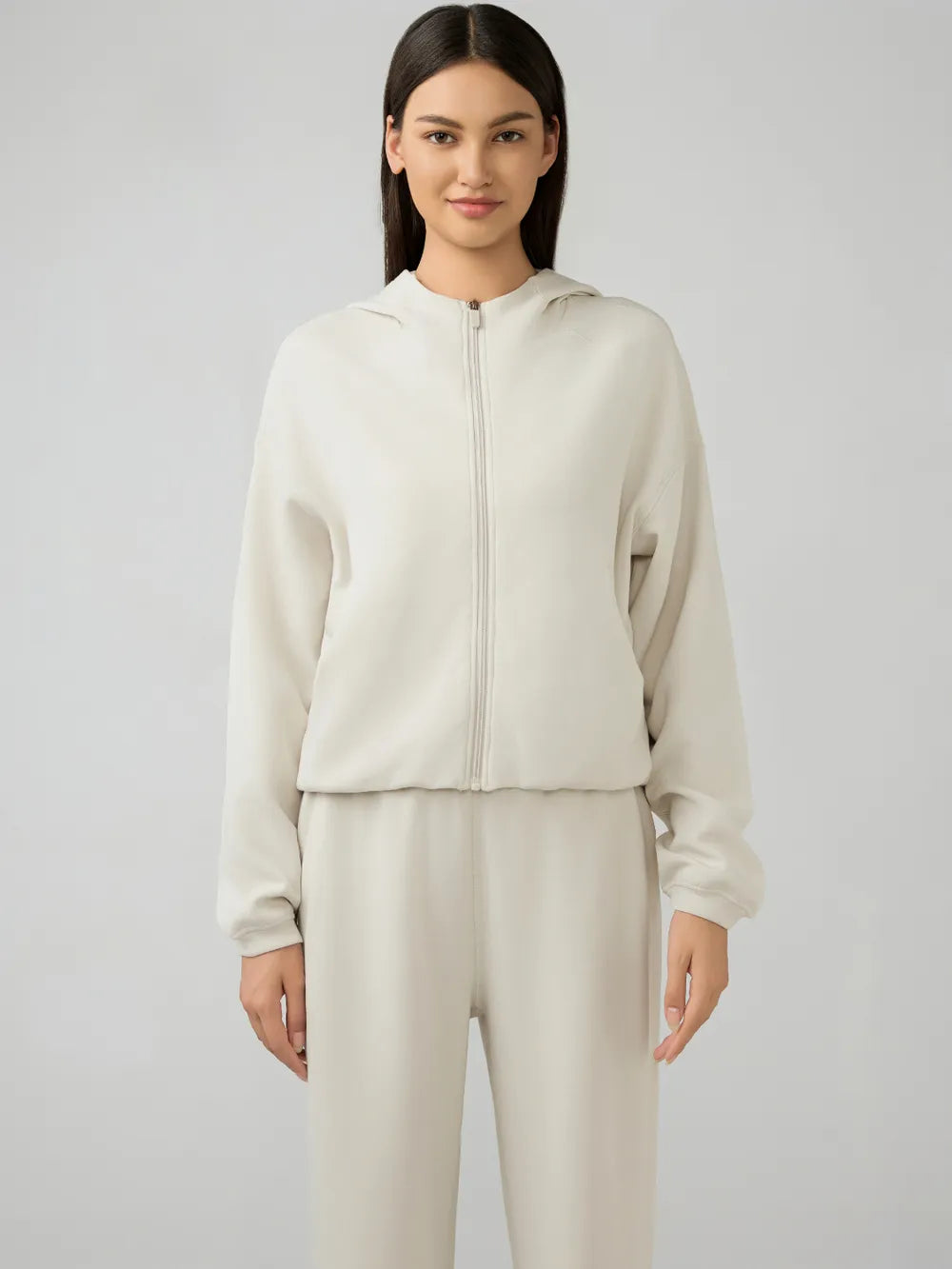 Cream zip-up hooded jacket with stand collar, front zipper, dropped shoulders
