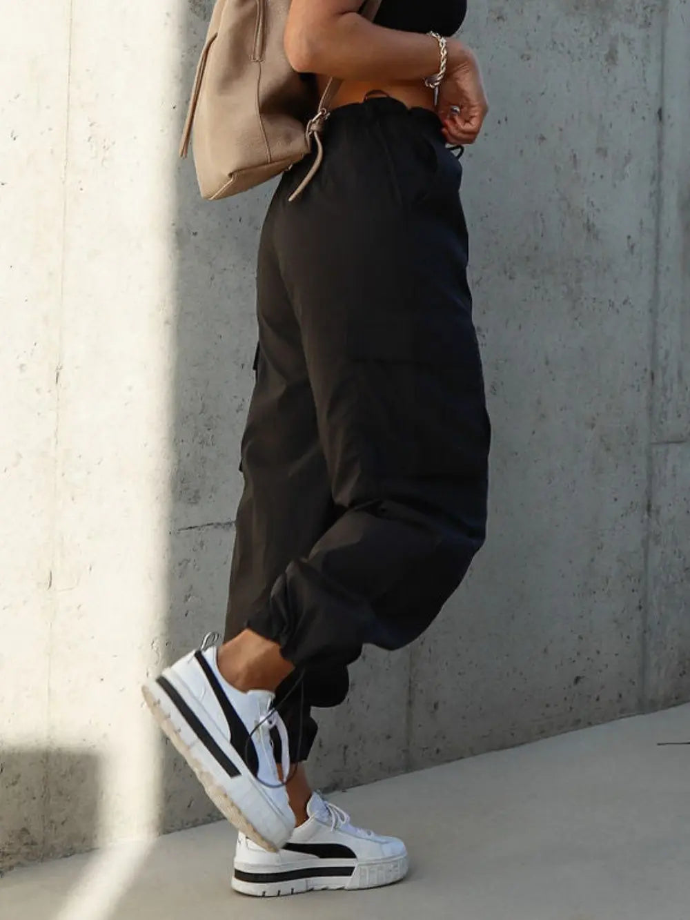 Black drawstring cargo pants with side pockets and cuffed ankles