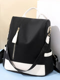 Black and white color block convertible backpack bag with front zippers and top handle